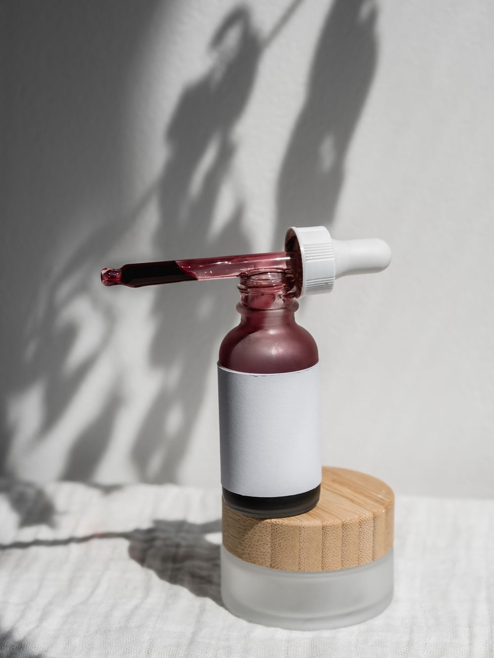 A skincare serum bottle with a dropper